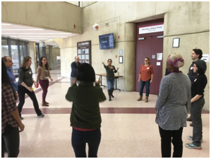 Students toss objects to each other in the interactive group activity