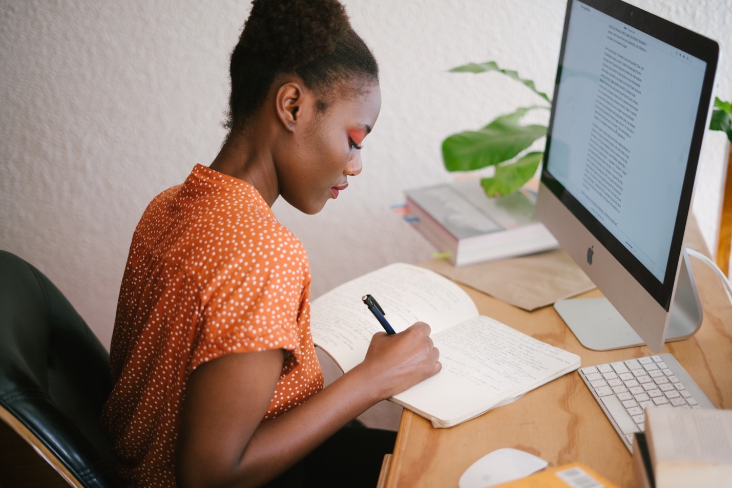 A woman sitting at a desk in front of a computer
